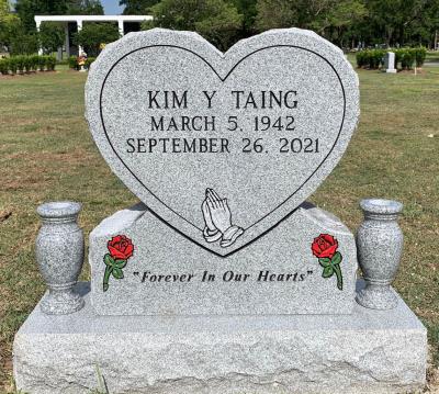 heart shaped headstone with red roses